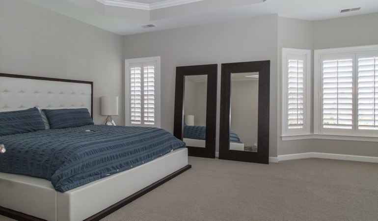 White shutters in a minimalist bedroom in Raleigh.